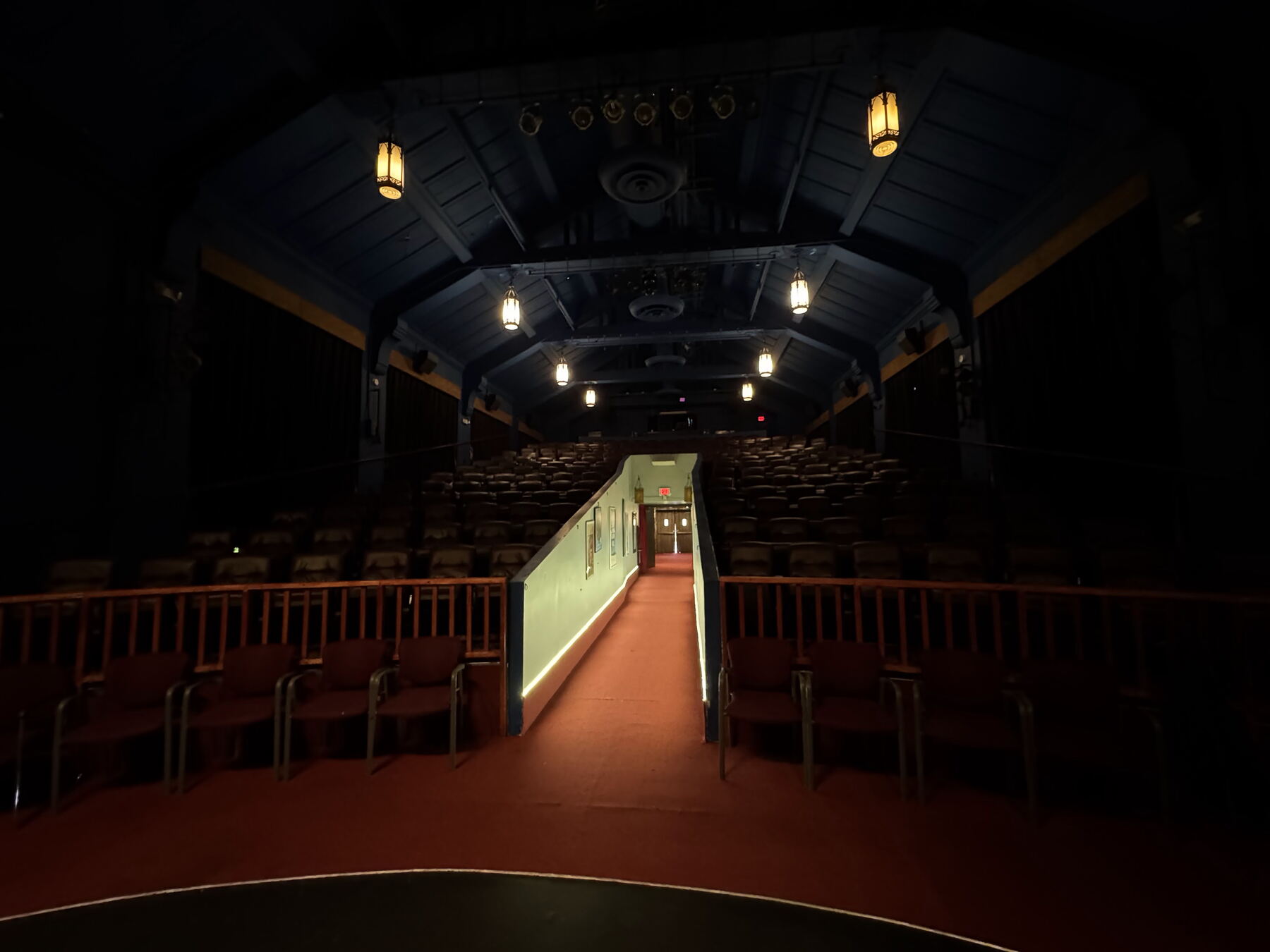 Savor Cinema auditorium from the stage, aisle leading up between rows of seats